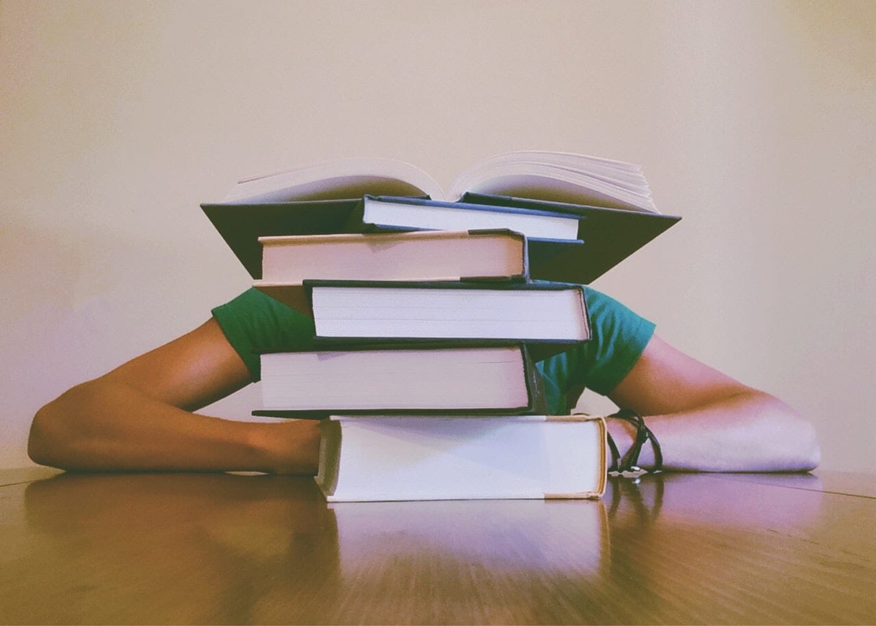 person with a stack of books