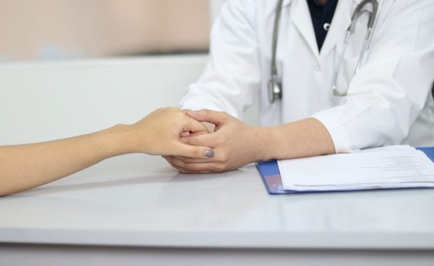 doctor holding a patient's hand