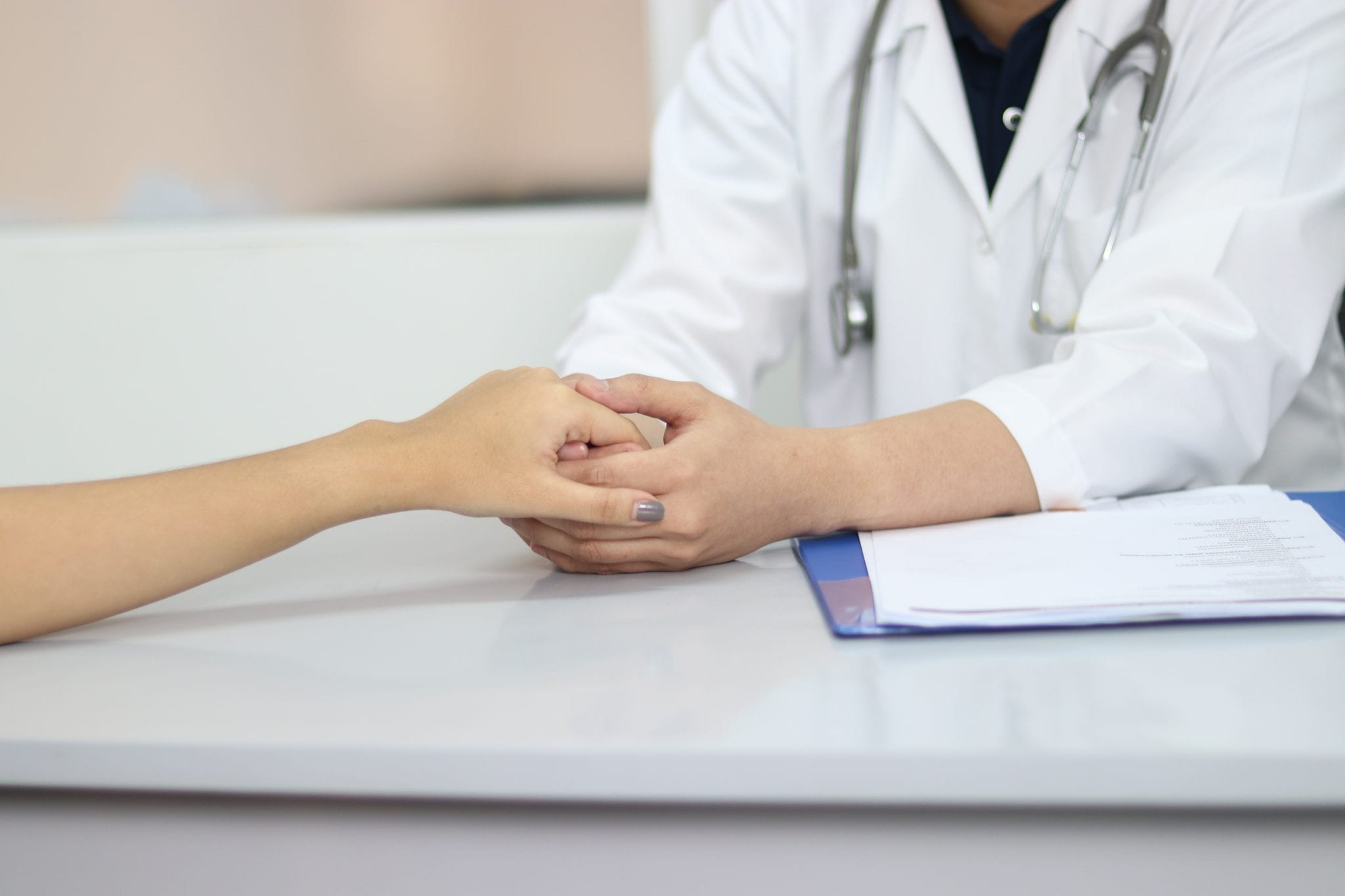 doctor holding a patient's hand